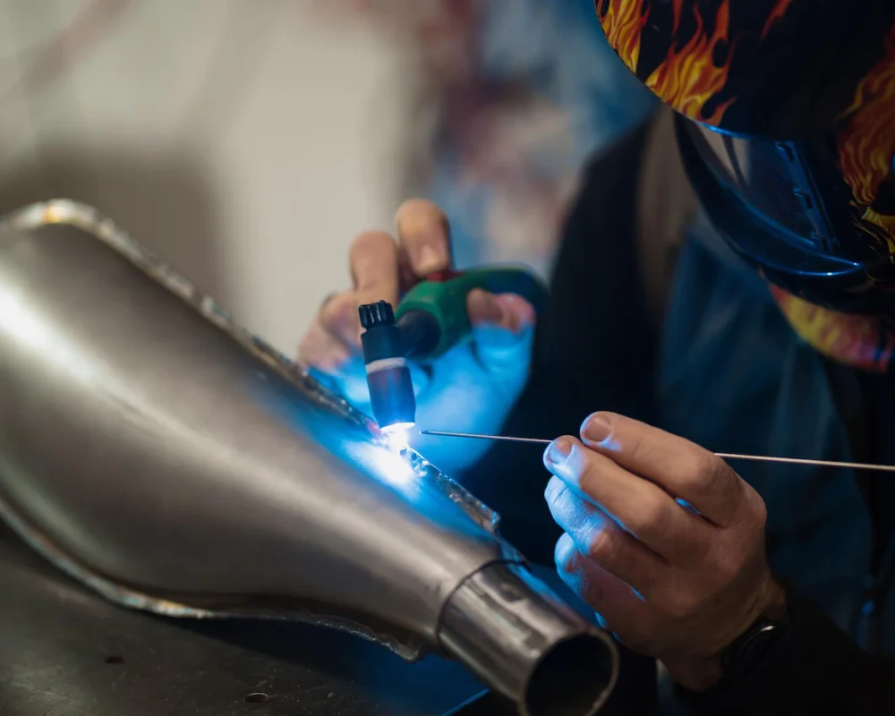man-fixing-motorcycle-modern-workshop_158595-8137