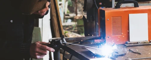 man-welding-old-shovel-close-up_127675-2554
